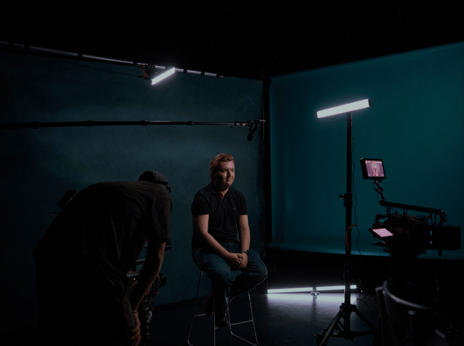 A young man sitting in a film studio