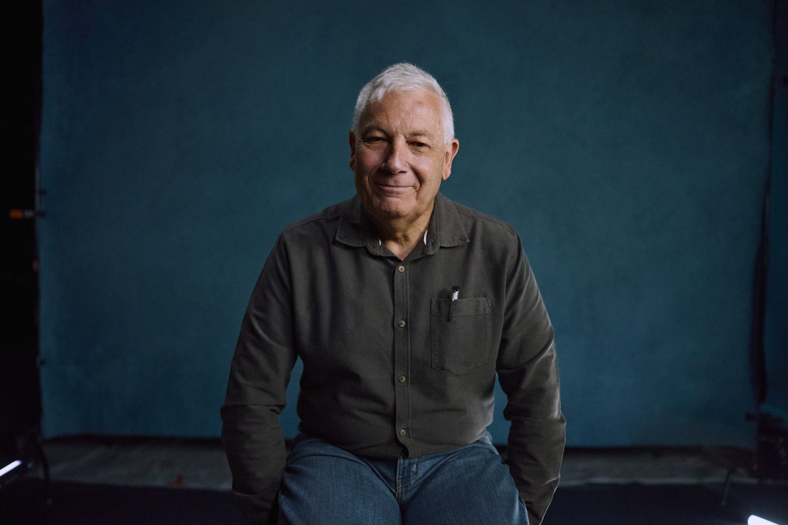 An older man looks at the camera